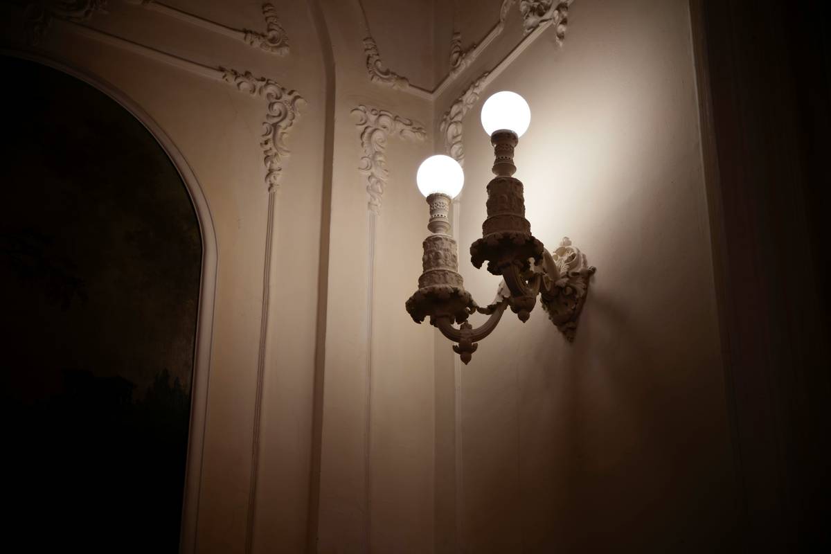 Diagram showing ambient, task, and accent lighting layers with wall sconces highlighting vertical illumination in hallways and beside mirrors