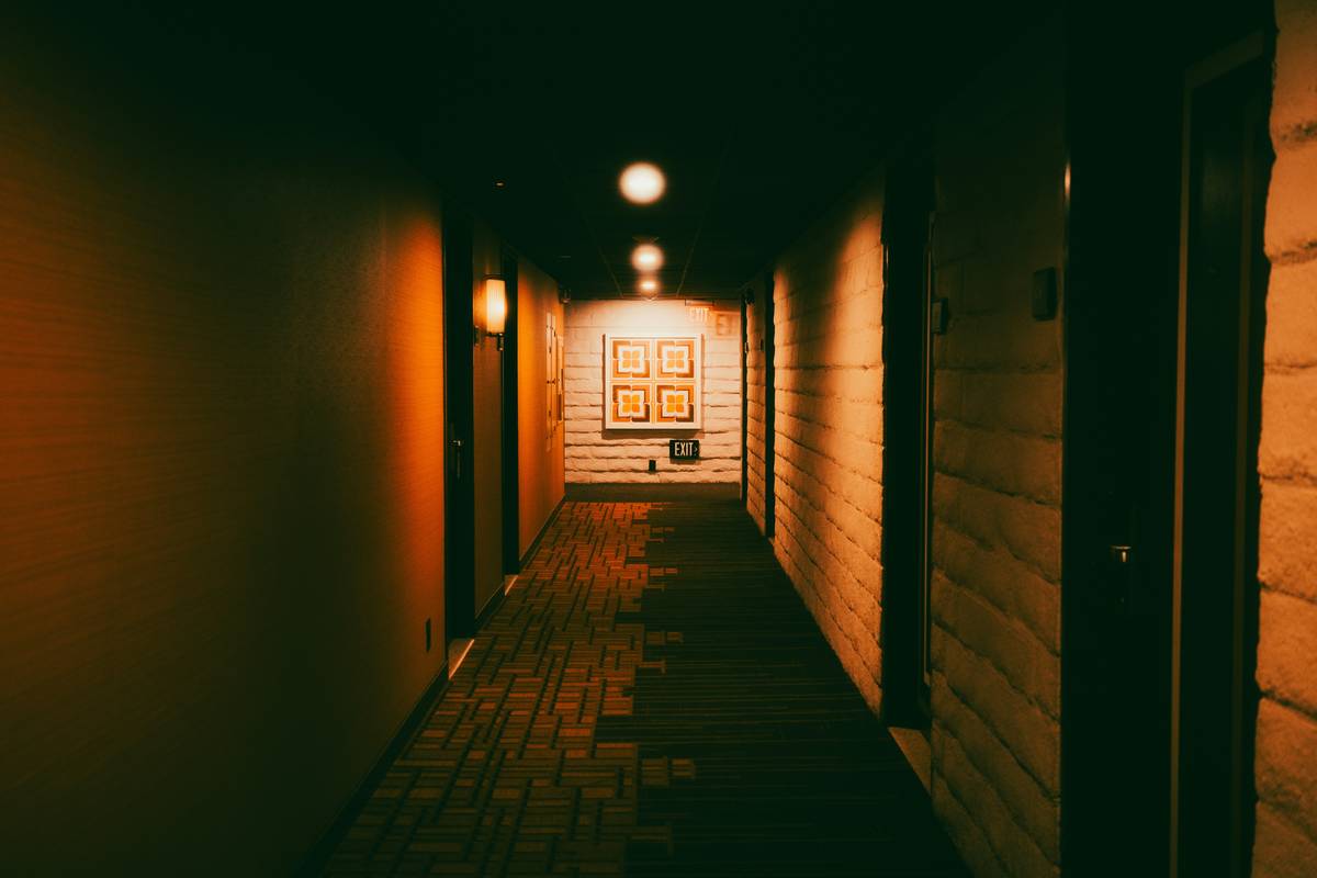 Diagram showing ideal wall sconce placement heights for hallways, bedrooms, and bathrooms with measurements in inches
