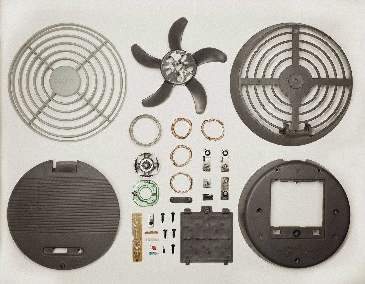 Labeled diagram of wall sconce light fixture parts including backplate, socket, wire nuts, mounting screws, shade, harp, and finial