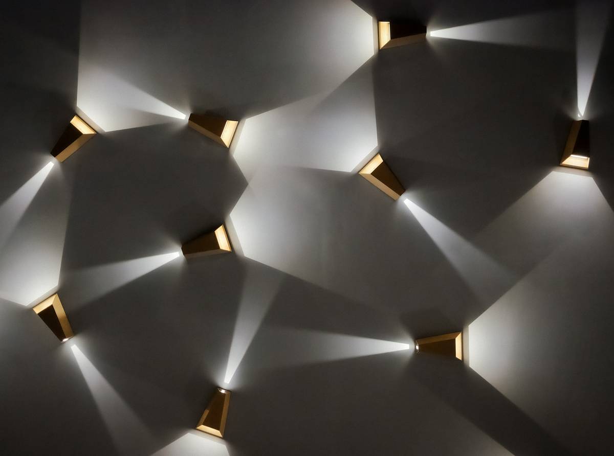 Elegant hall sconce lighting fixtures flanking a mirror in a minimalist entryway