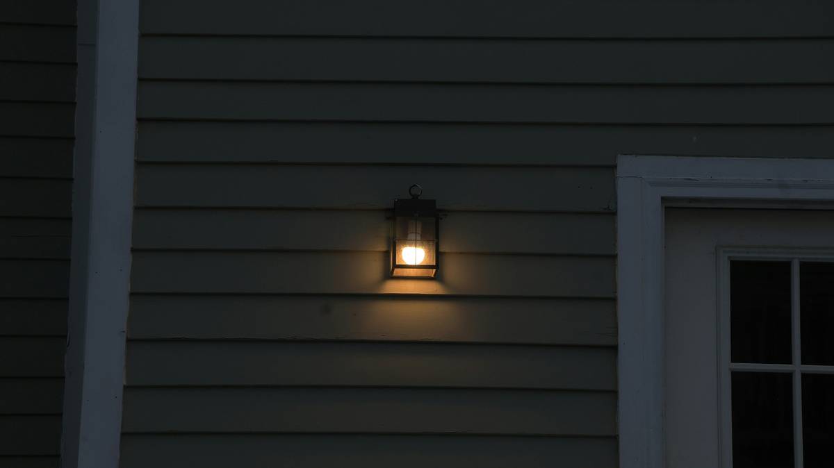Close-up of weatherproof exterior sconce lighting fixtures led showing IP65 rating label and brass finish