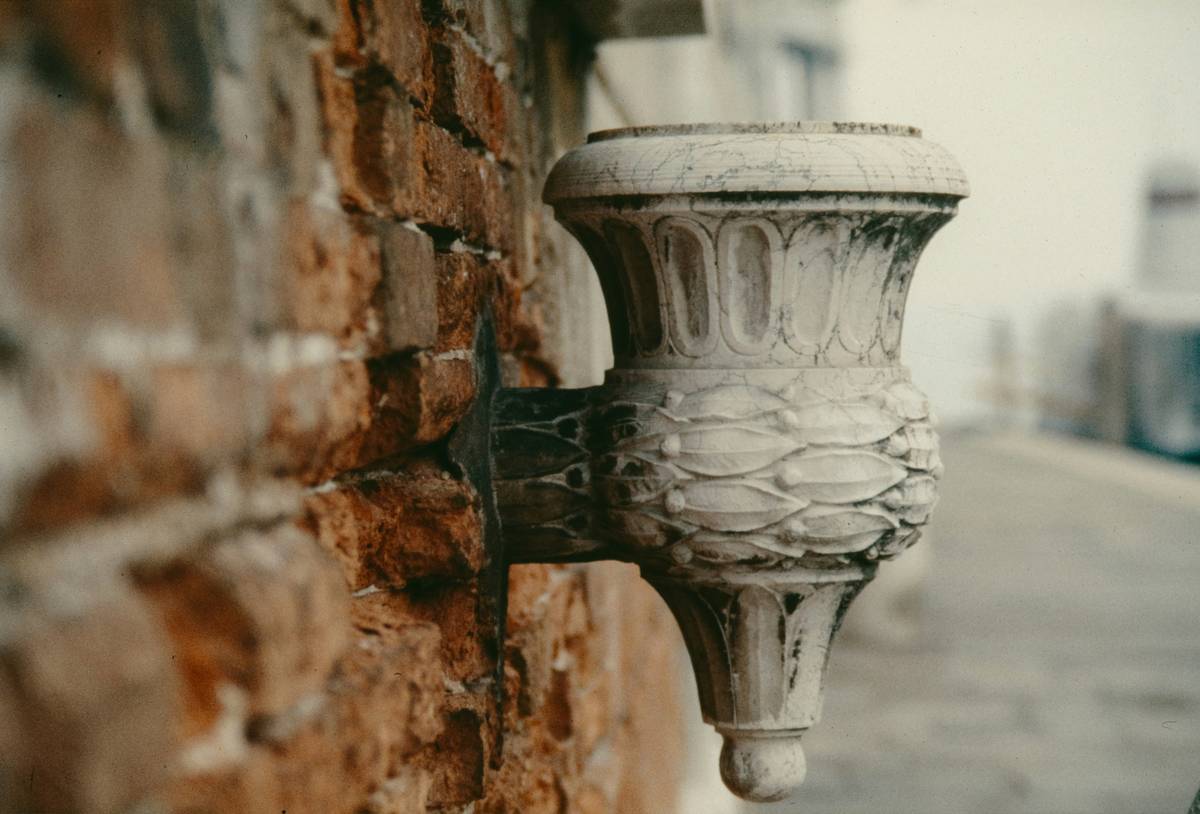 Side-by-side comparison: authentic brass French wall sconce vs. cheap resin imitation showing material texture, finish durability, and shade quality