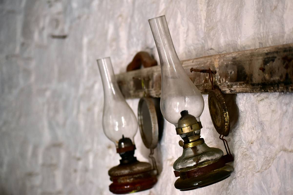 Modern hall sconce lighting fixtures installed at 64 inches highlighting textured wallpaper