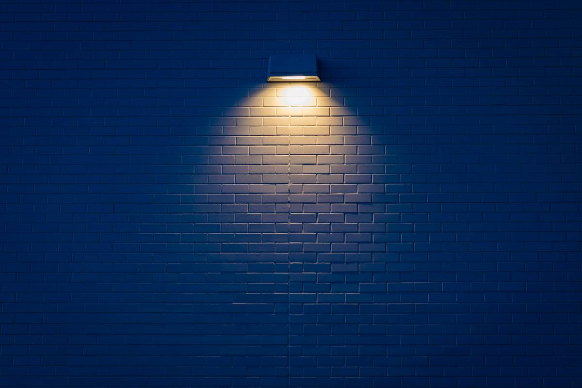 Modern lighting fixtures wall sconces mounted beside a bathroom mirror, casting even, shadow-free illumination